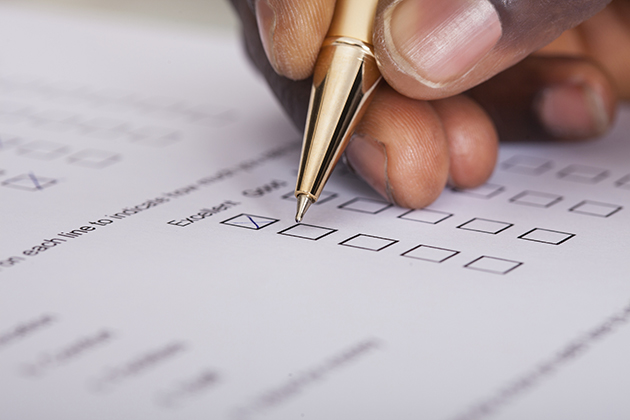 Close-up of a person filling out a survey form. (iStock/UConn Photo)