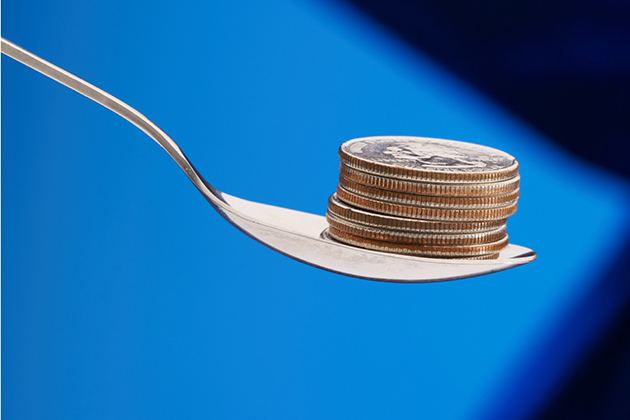 A spoon with cash, representing a cash reward for weight loss. (iStock Photo)