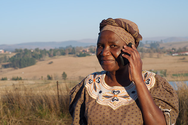 An African woman uses a cell phone. (Shutterstock Photo)
