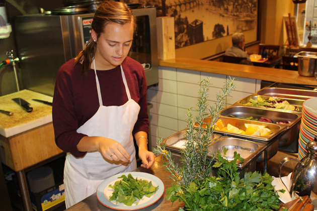 Maureen Megson '15 (CAHNR) prepares a salad at LaSpada Restaurant in Florence. (Photo courtesy of CAHNR)