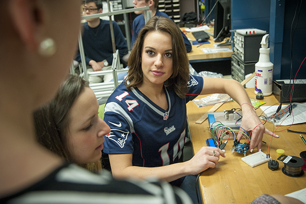 Alyssa Merkle '15 (ENG), Patriots cheerleader, works on her senior project in engineering. (Sean Flynn/UConn Photo)