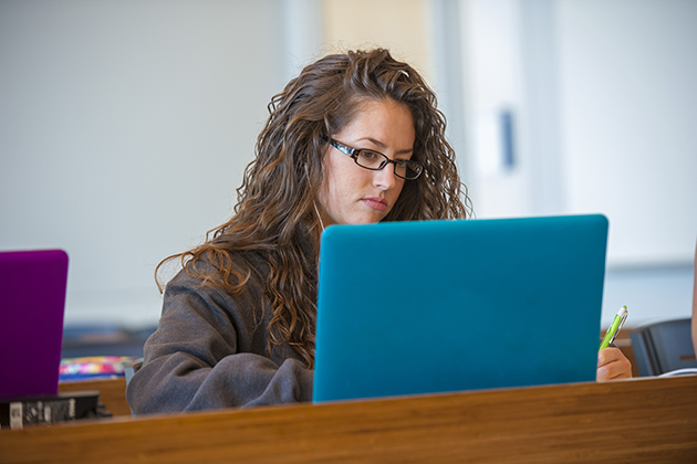 A student studying on her computer. (Sean Flynn/UConn Photo)