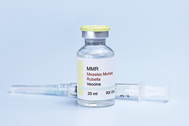 A bottle of MMR vaccine with a syringe. (Shutterstock Photo)