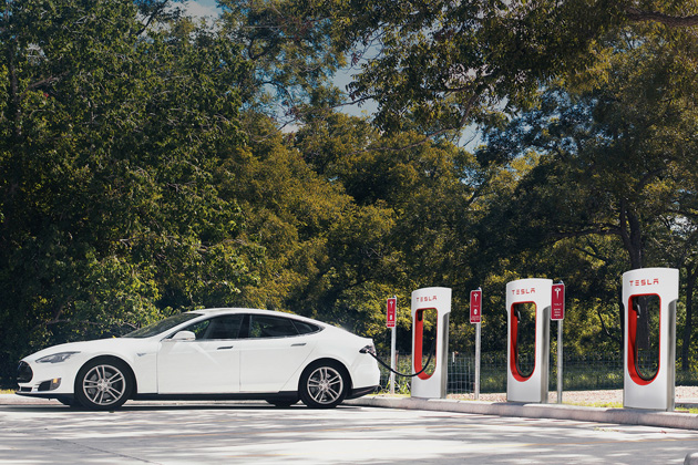 Tesla advertises a model plugged into an electric charging station. (Tesla Motors)