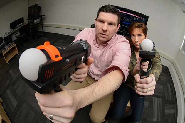 Rory McGloin and Kirstie Farrar with a video game on March 12, 2015. (Peter Morenus/UConn Photo)