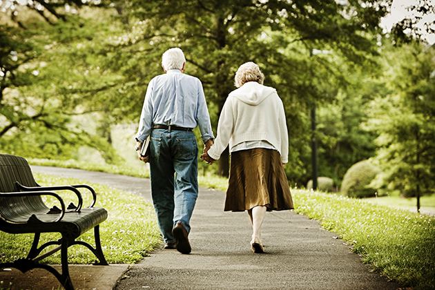 Elderly couple walking in a park. (iStock Photo)