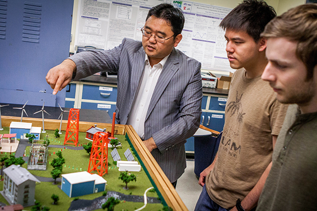 Sung-Yeul Park, recent winner of an NSF CAREER award, with an energy system model. Park specializes in developing “Smart Grid” systems capable of accepting energy from a wide range of power sources, including wind, solar, and fuel cells on April 20, 2015. (Christopher LaRosa/UConn Photo)