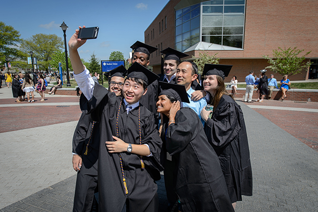 A group of degree candidates from the College of Liberal Arts & Sciences pose with Young-Chan Son, a lecturer in chemistry at the Avery Point Campus before their Commencement ceremony at Gampel Pavilion on May 10, 2015. (Peter Morenus/UConn Photo)