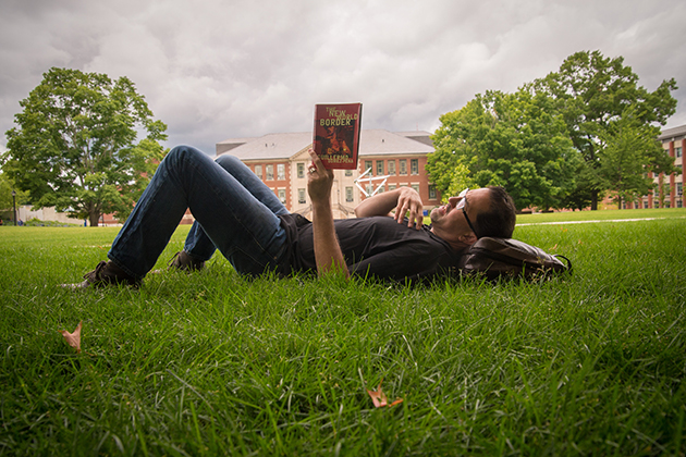 Professor Mark Overmyer-Velázquez reading a book on June 29, 2015. (Sean Flynn/UConn Photo)