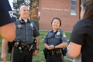 New UConn police officers Gary Bourgoin and Susannah Hildebidle speak with students outside Oliver Ellsworth Hall on Aug. 28, 2015. (Peter Morenus/UConn Photo)