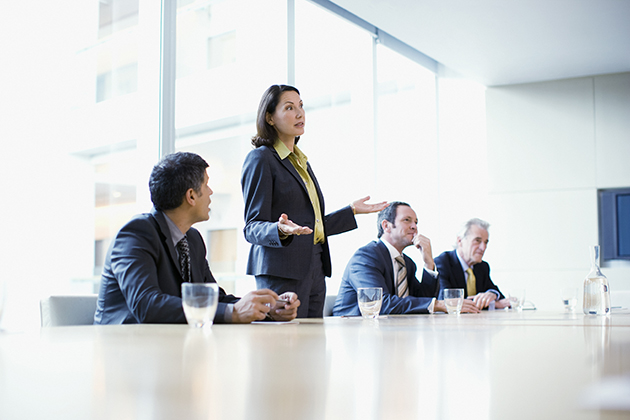 Businesswoman giving presentation in conference room. (iStock Photo)