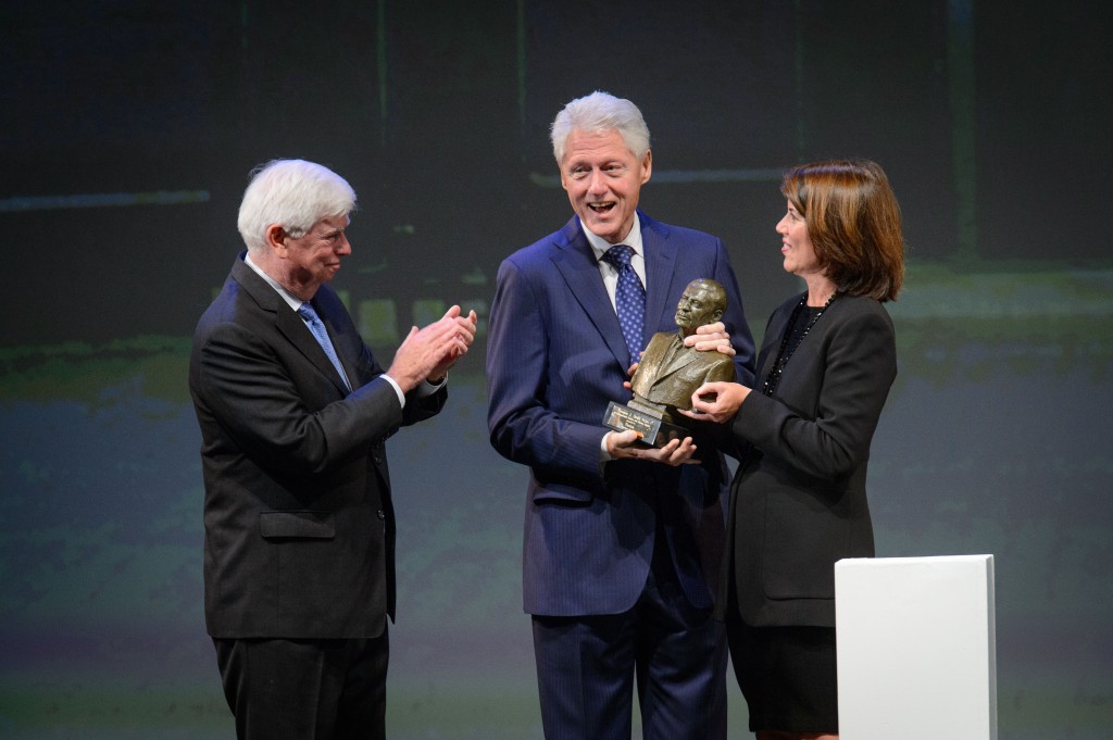 President Bill Clinton, center, receives an award from former Senator Christopher Dodd, left, and Helena Folks, chair of the national advisory board during the ceremony to award the Thomas J. Dodd Prize in International Justice and Human Rights held at the Jorgensen Center for the Performing Arts on Oct. 15, 2015. (Peter Morenus/UConn Photo)