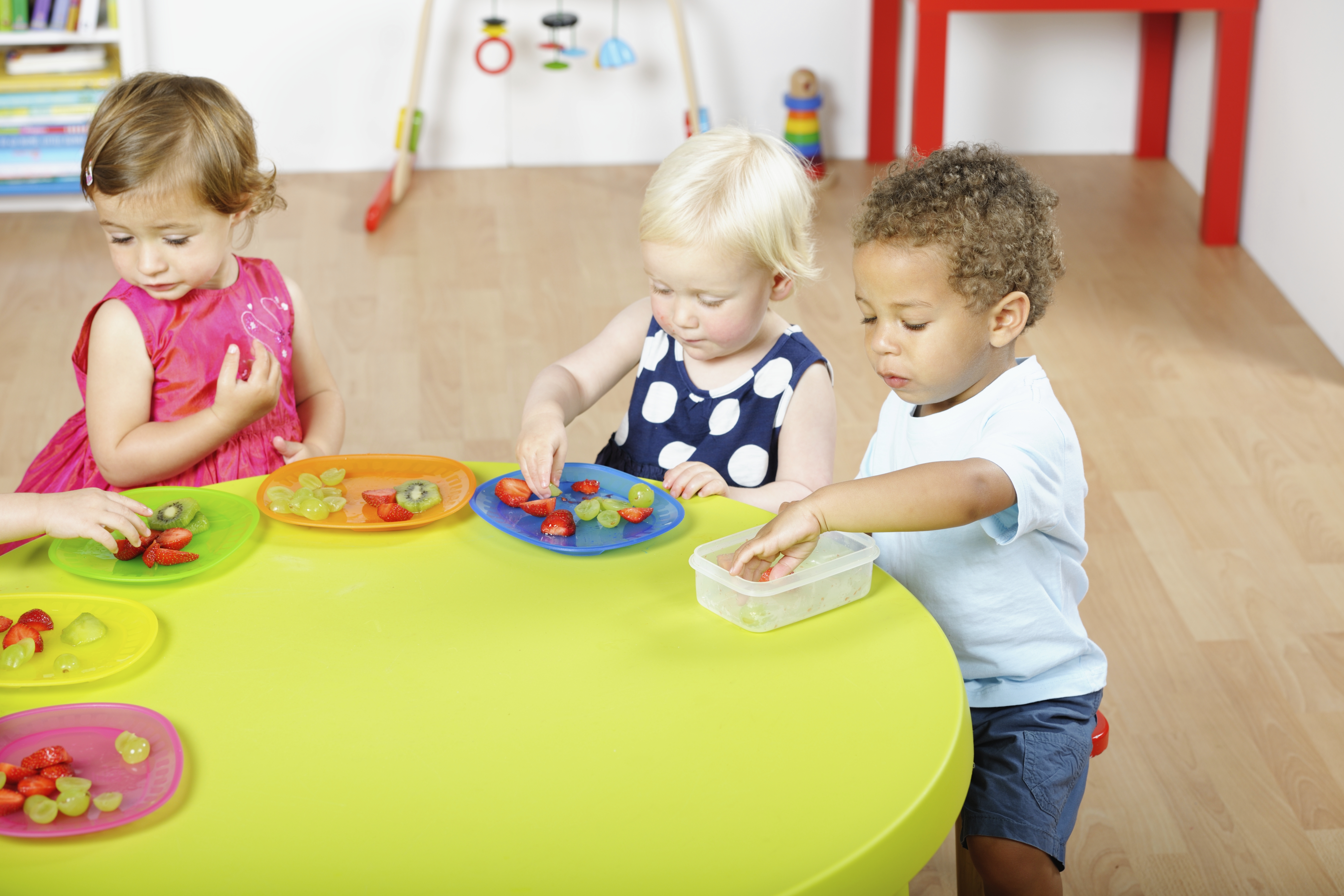 Young children eating healthy snacks in a day care setting. (iStock Photo)