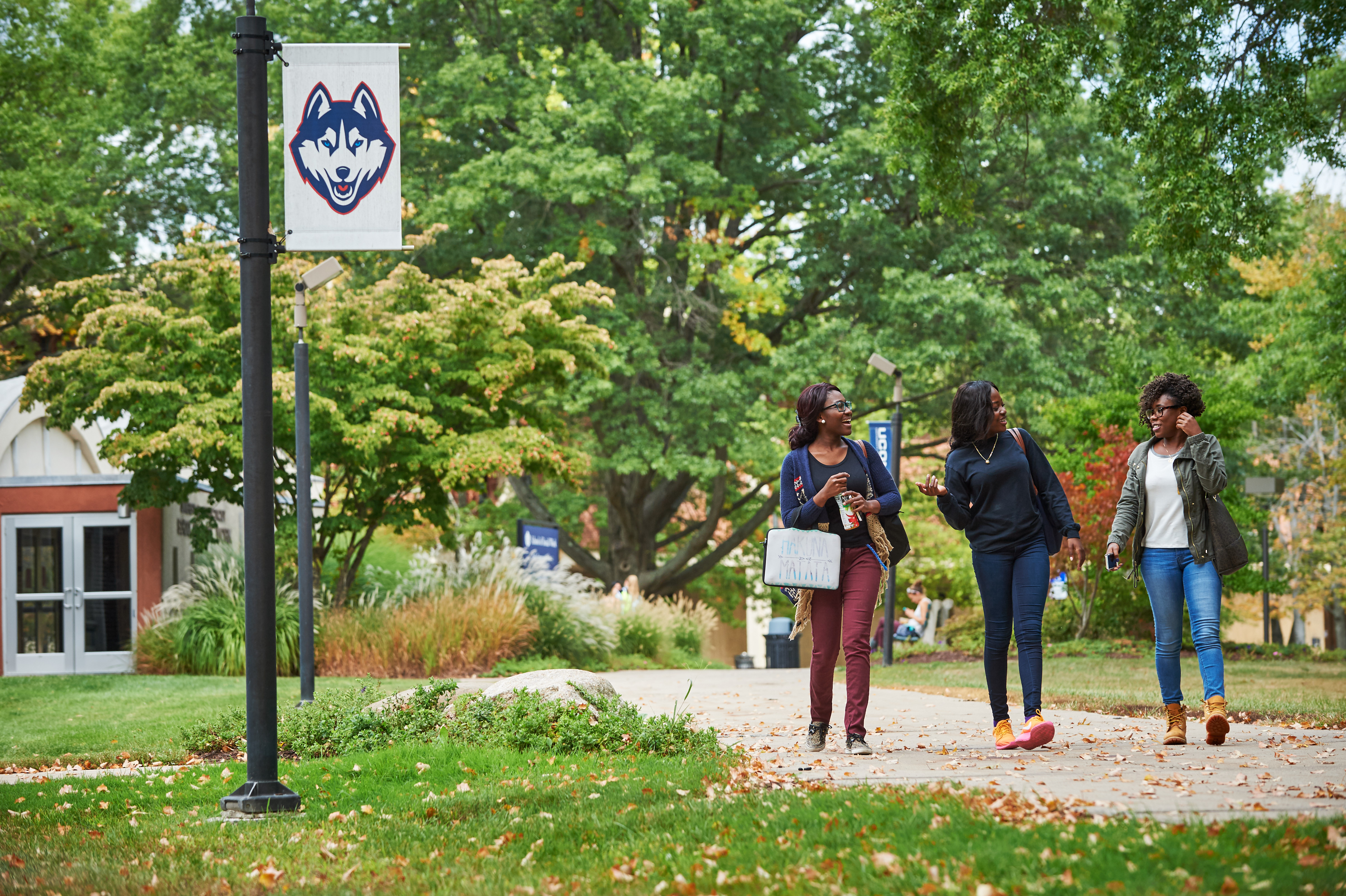 Students walk outdoors near banners on the Hartford campus. (Peter Morenus/UConn Photo)