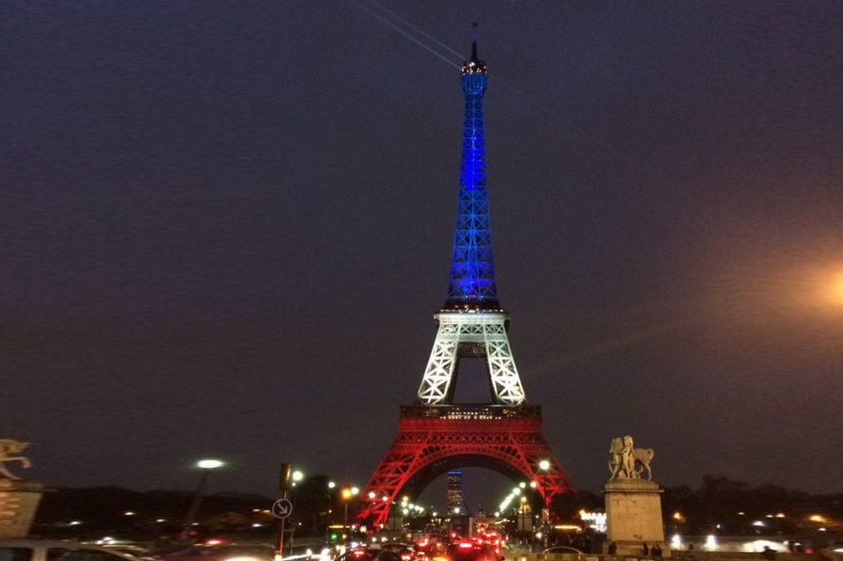The Eiffel Tower in Paris, lit up in red, white, and blue.