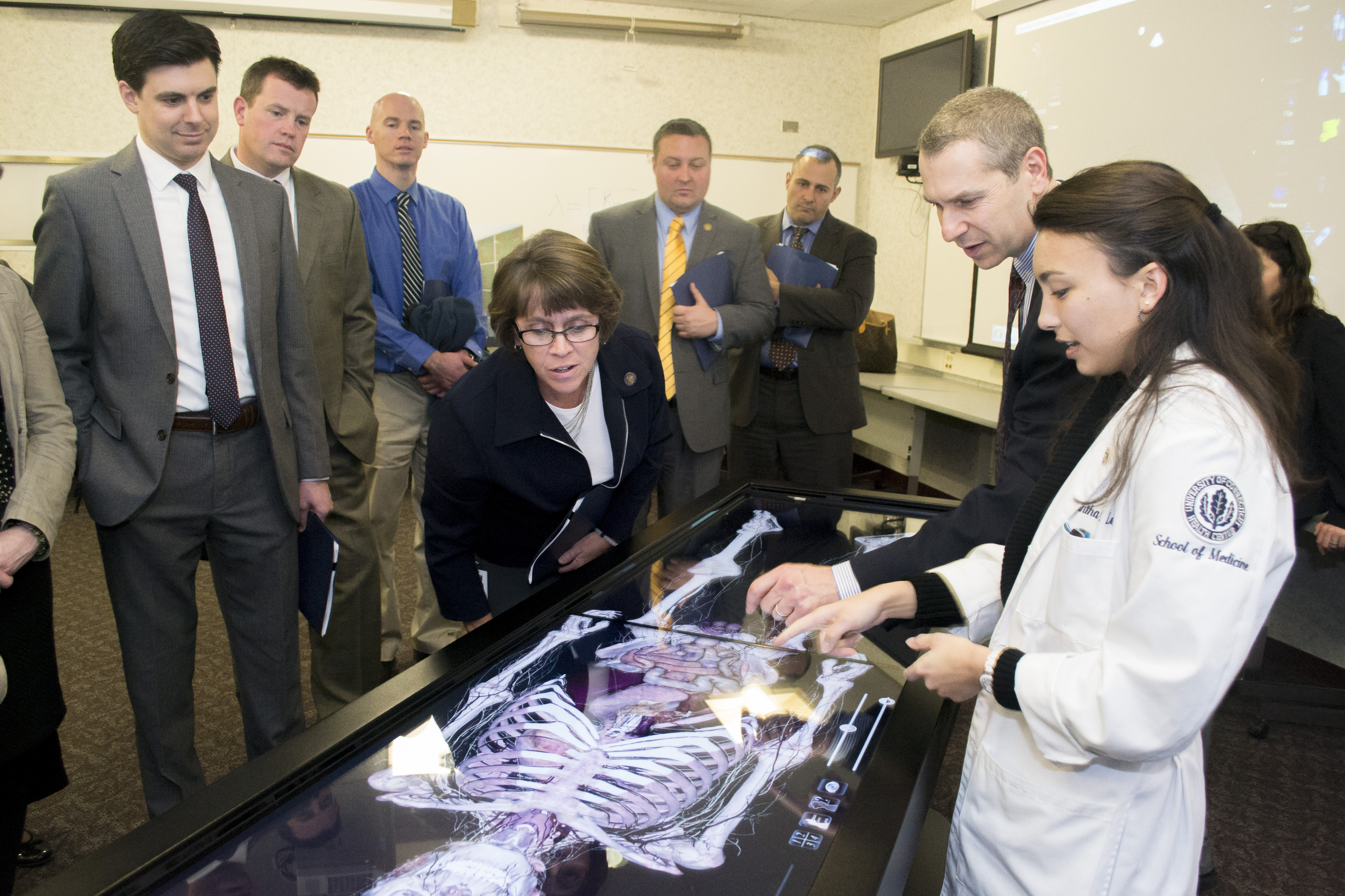 Connecticut state legislators listen as medical student Samantha Lee uses the Anatomage, virtual anatomy table, during a tour of the the recently renovated research and academic facilities at UConn Health. (Tina Encarnacion/UConn Health)