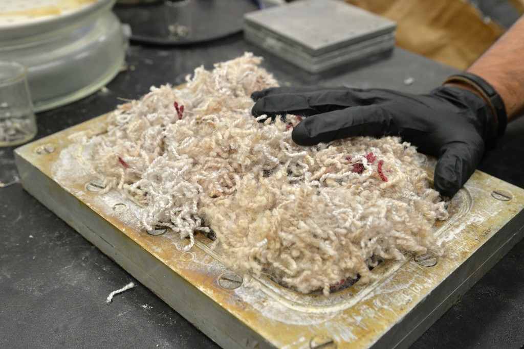 Daniel Kloyzner ‘16 (ENG) with Richard Parnas, a professor of chemical, materials, and biomolecular engineering, has found a way to turn particle board into carpet. (Sean Flynn/UConn Photo)