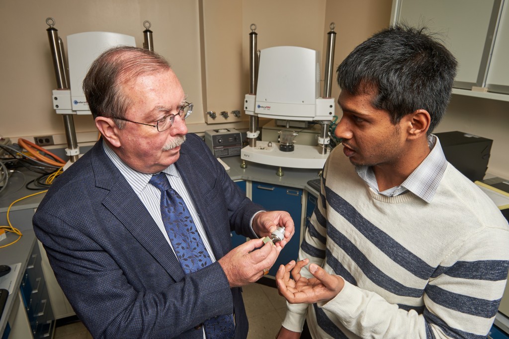 Gopinath Rajadinakaran, right, and Robert Kelley, professor of reconstructive sciences, discuss the testing of an artificial salivary gland at UConn Health in Farmington on Dec. 3, 2015. (Peter Morenus/UConn Photo)