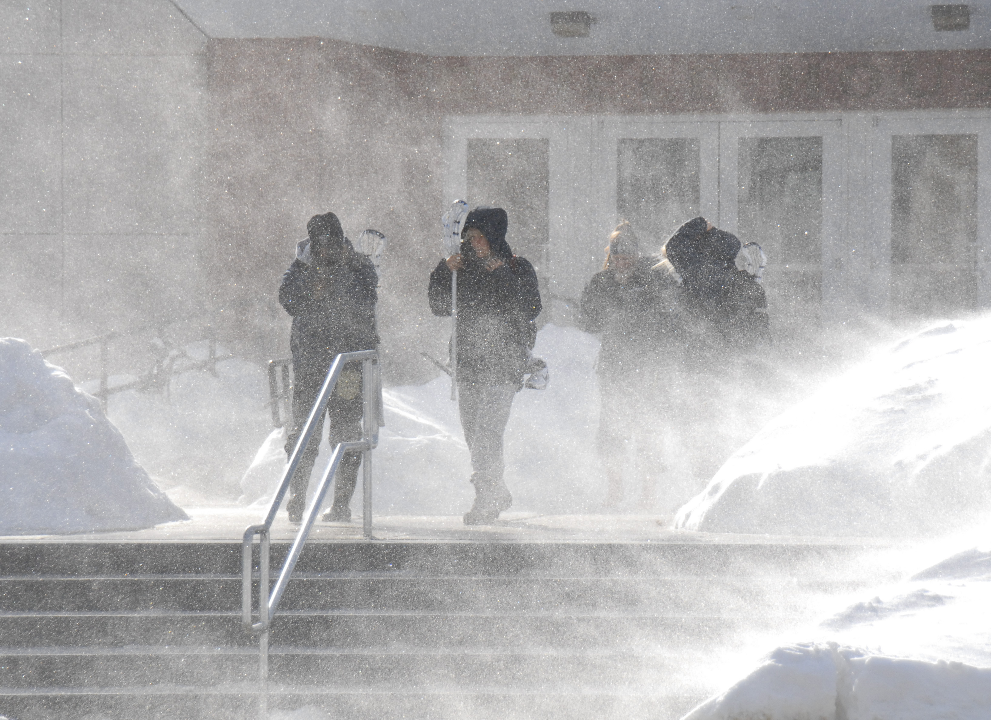 Students are overwhelmed with snow as they exit the Field House. (UConn File Photo)