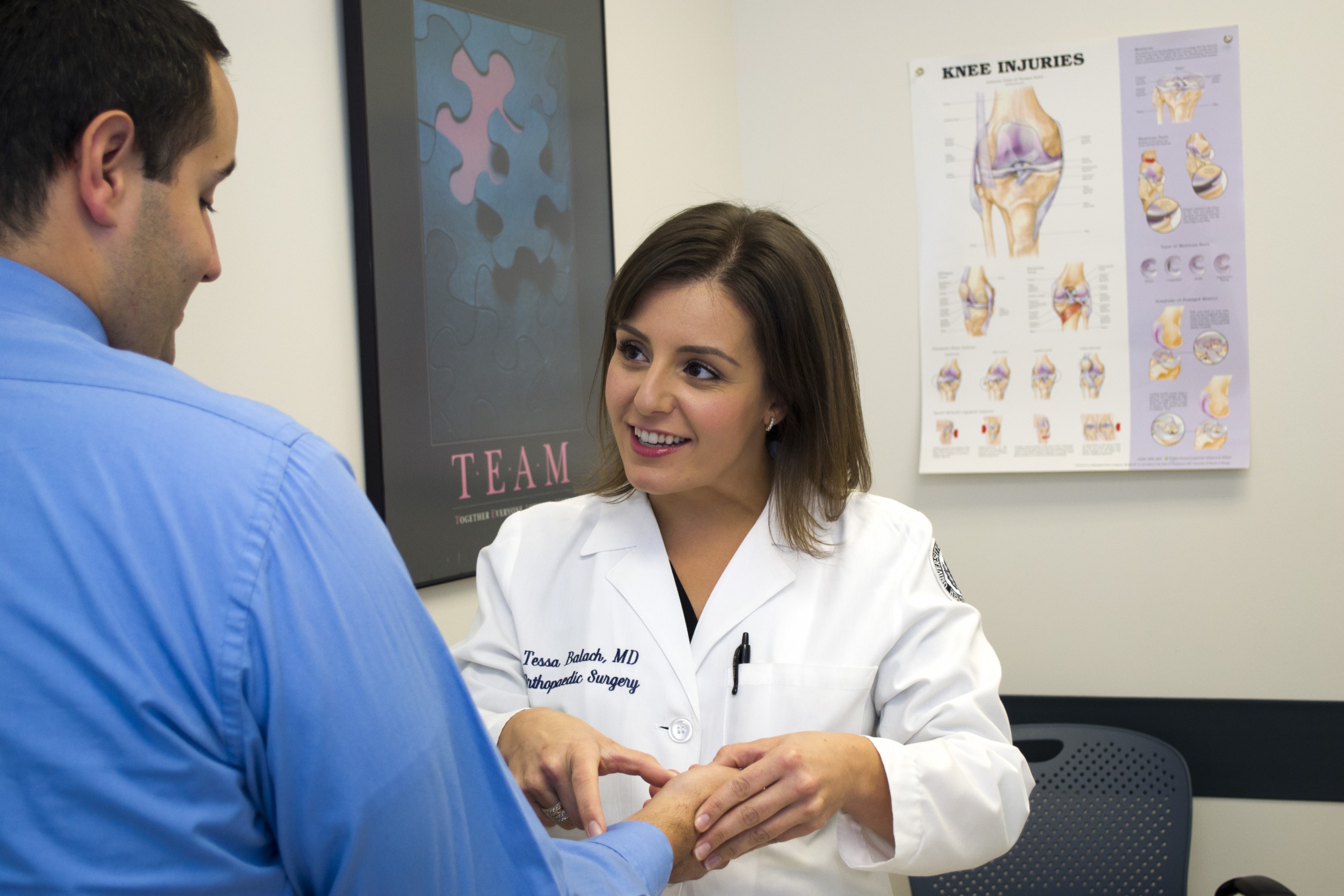 Dr. Tessa Balach speaks with a patient. (Tina Encarnacion/UConn Health Photo)