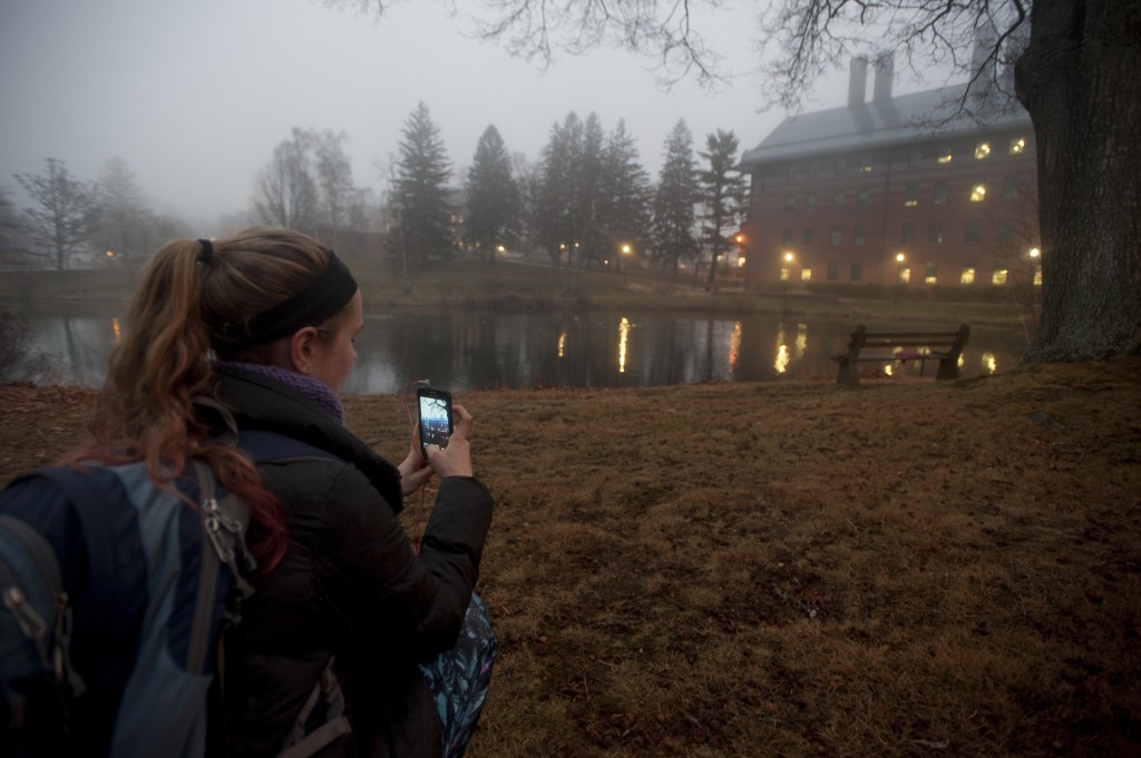 A student takes a photo of the Chemistry Building on her smartphone. (Sean Flynn/UConn Photo)