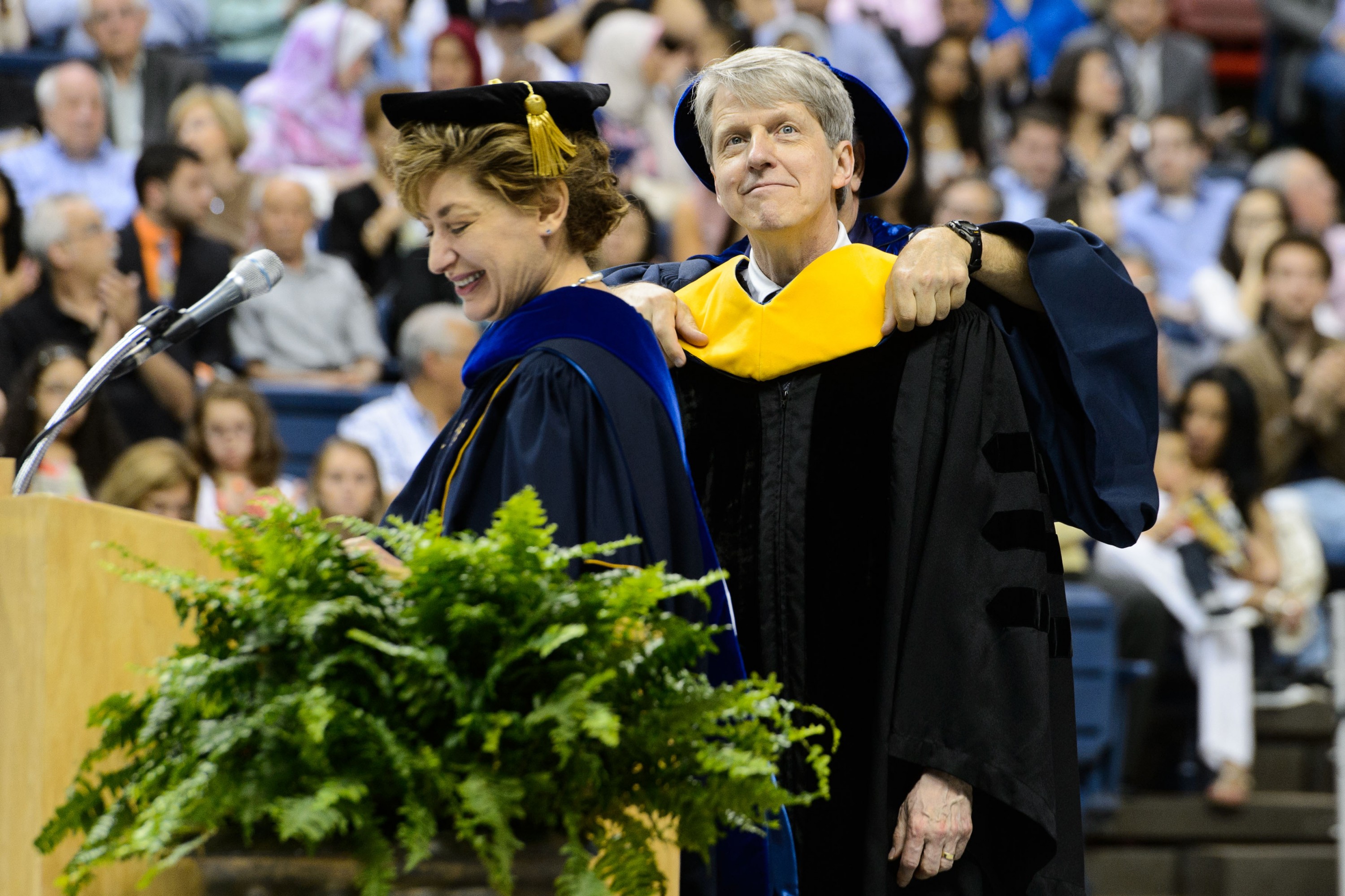 President Susan Herbst reads the citation to award Robert J. Schiller an honorary degree during the School of Business Commencement ceremony at Gampel Pavilion on May 10, 2015. (Peter Morenus/UConn Photo)