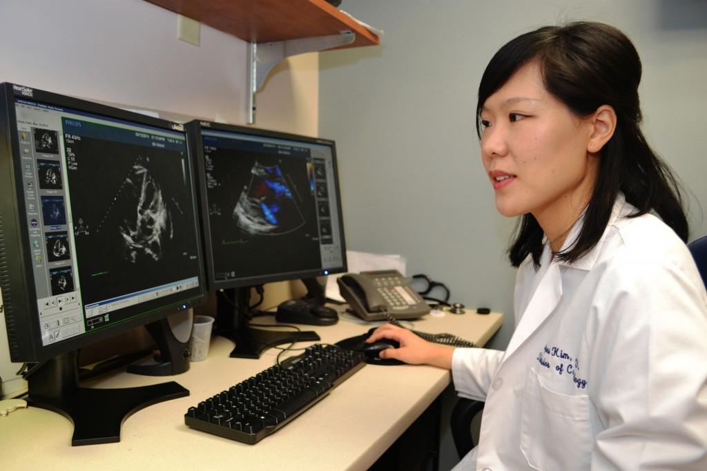 Reading echocardiography images is one way Dr. Agnes Kim monitors cancer survivors' risk for heart disease as part of UConn Health's Cardio-Oncology Program. (Tina Encarnacion/UConn Health Photo)