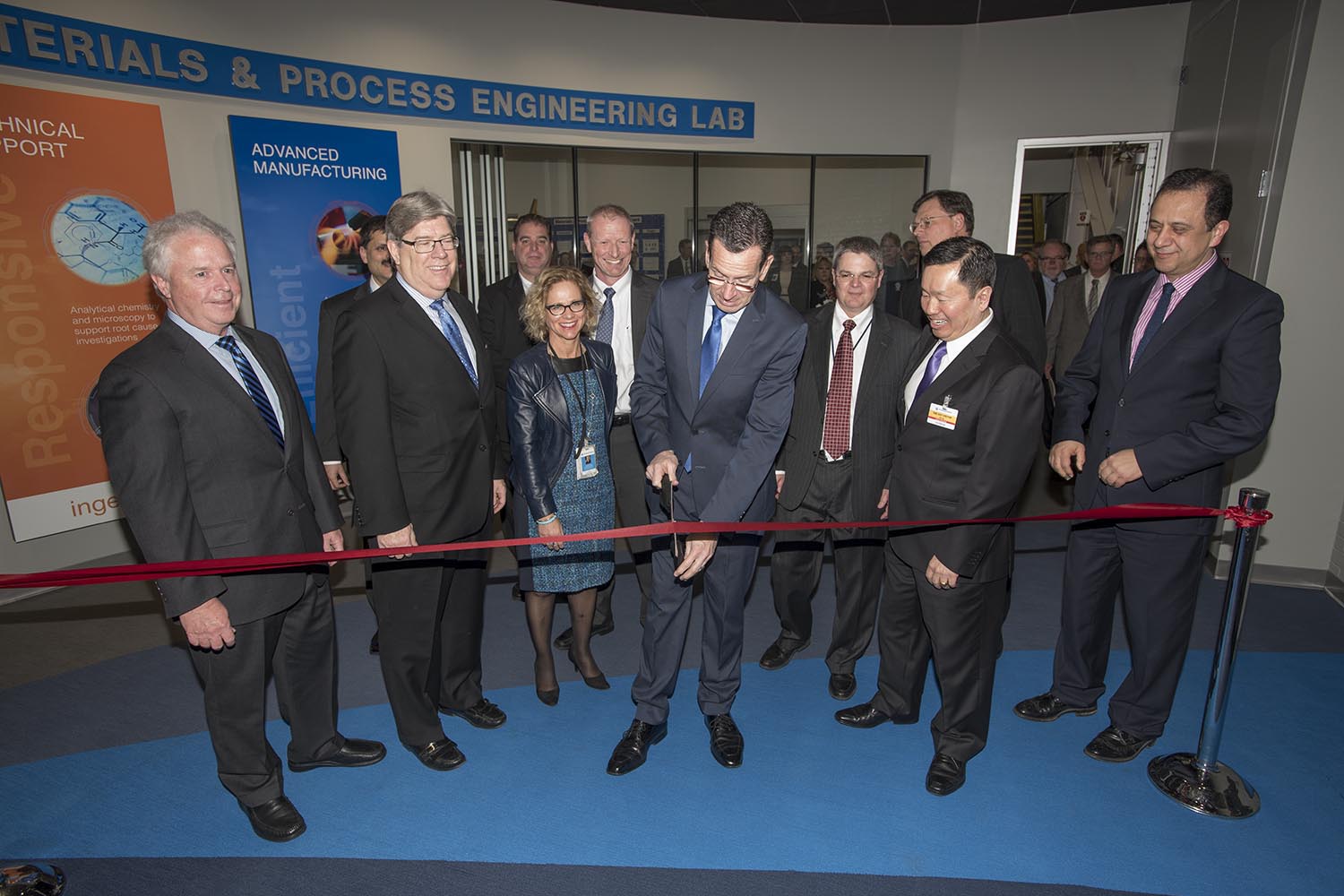 Governor Dannel P. Malloy cuts a ribbon at the new UTAS lab. Front from left to right is Dave Carter, Senior Vice President, Engineering, Operations and Quality, UTC Aerospace Systems, J. Michael McQuade, Senior Vice President of Science and Technology, United Technologies, Malloy, and UConn Provost Mun Choi, with other prominent United Technologies officials and dignitaries present.Governor Dannel P. Malloy cuts a ribbon at the new UTAS lab. Front from left to right is Dave Carter, Senior Vice President, Engineering, Operations and Quality, UTC Aerospace Systems, J. Michael McQuade, Senior Vice President of Science and Technology, United Technologies, Malloy, and UConn Provost Mun Choi, with other prominent United Technologies officials and dignitaries present.
