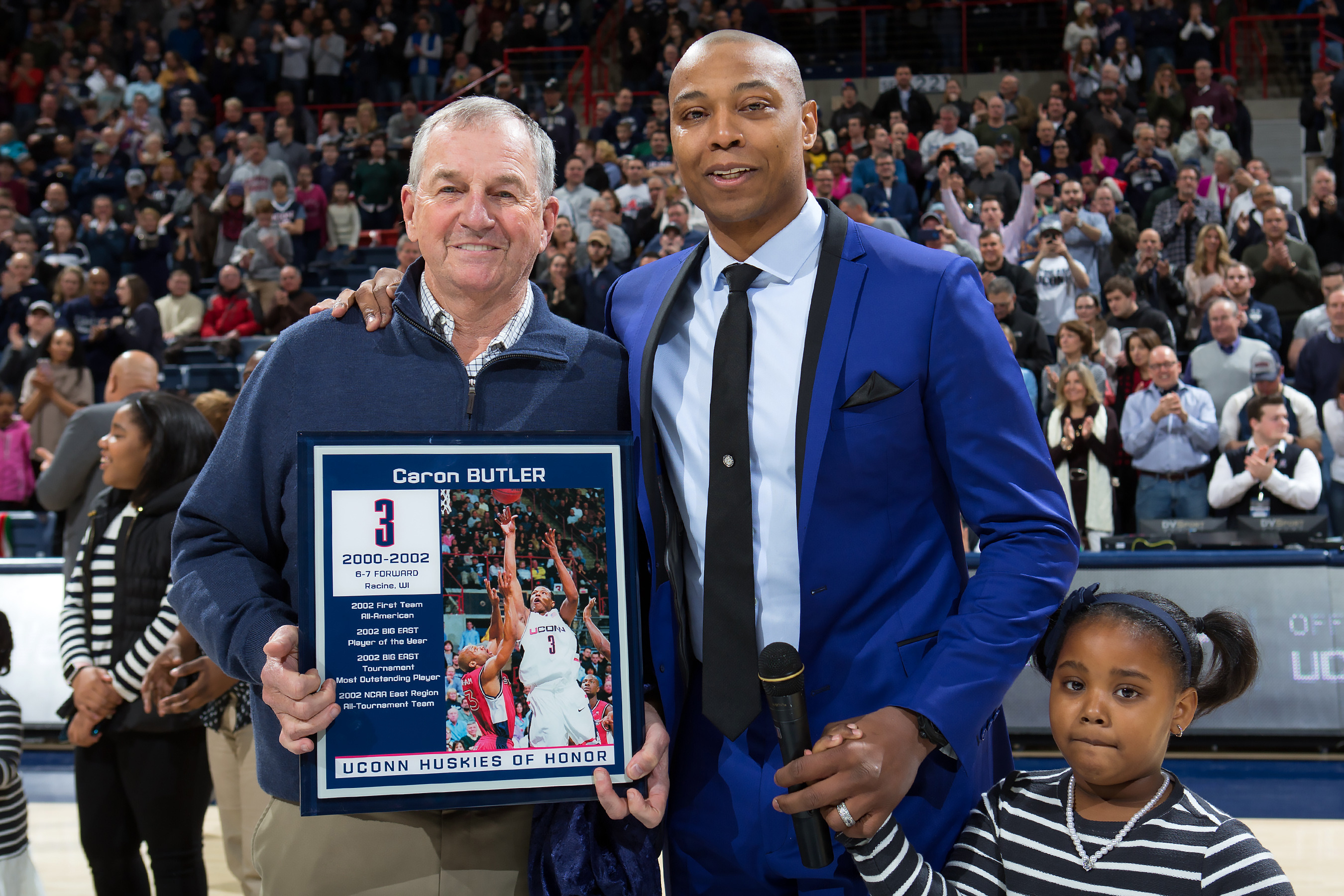 Former Husky Caron Butler celebrates his induction into Huskies of Honor along with his former coach, Jim Calhoun, and his daughter. (UConn Athletic Communications Photo)