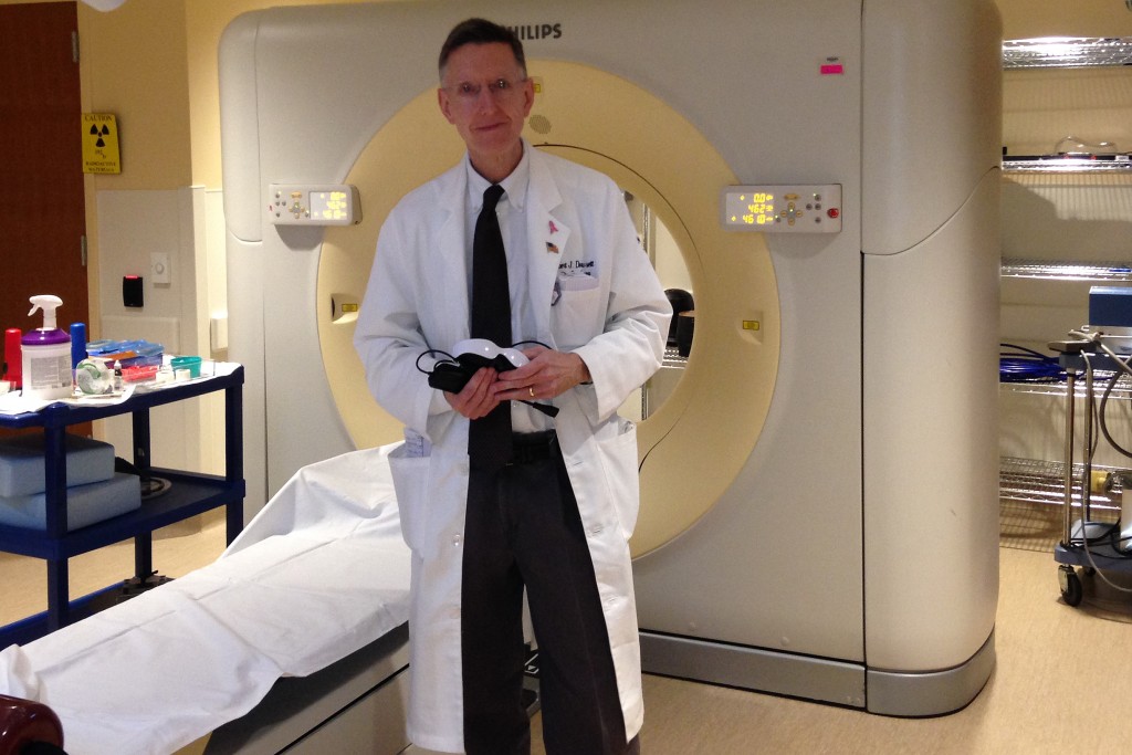 Radiation oncologist Dr. Dowsett with CT Scan technology in the Radiation Planning (simulation) Room at the Carole and Ray Neag Comprehensive Cancer Center at UConn Health. (Lauren Woods/UConn Health Photo)