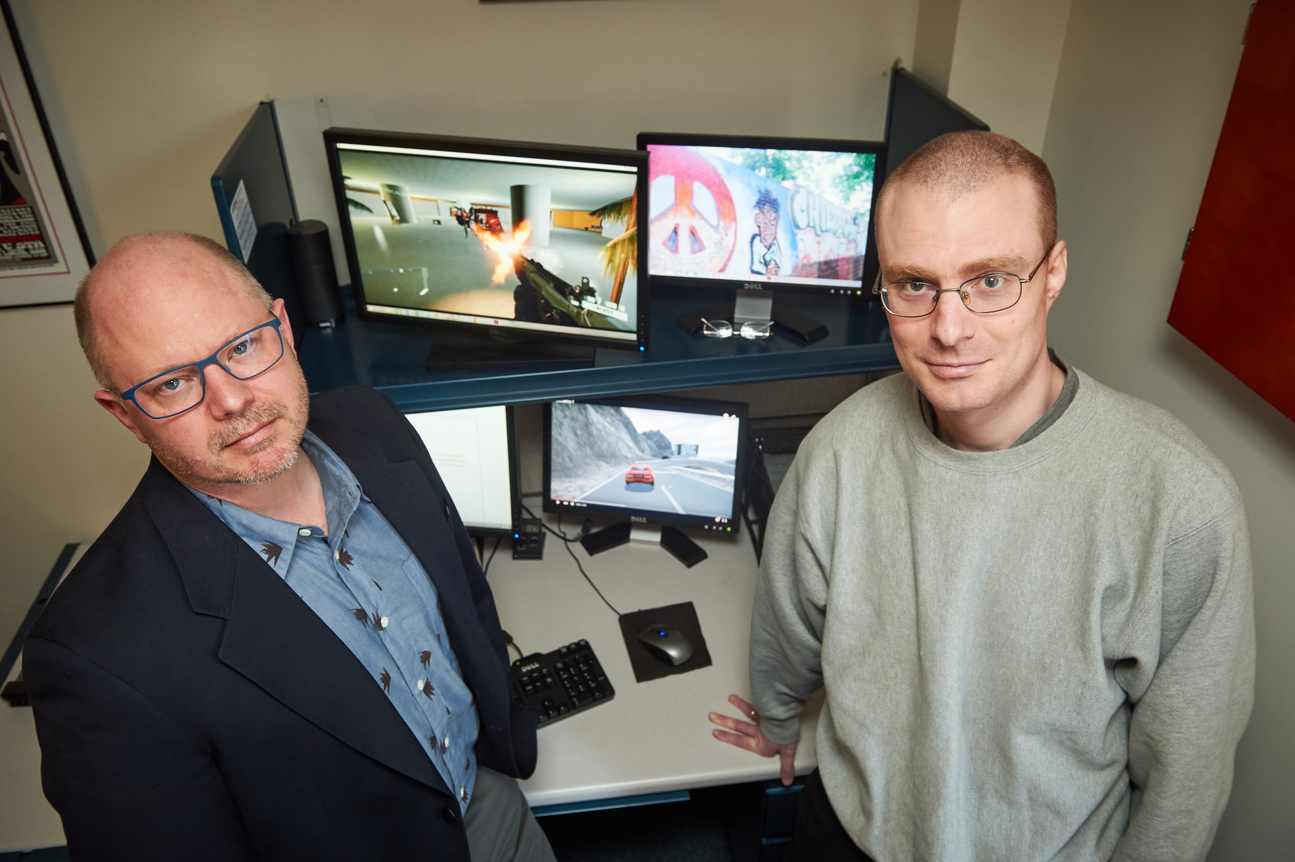 Hart Blanton, left, professor of psychology, and postdoc Chris Burrows '15 Ph.D. study video games with embedded health messages on March 9, 2016. (Peter Morenus/UConn Photo)