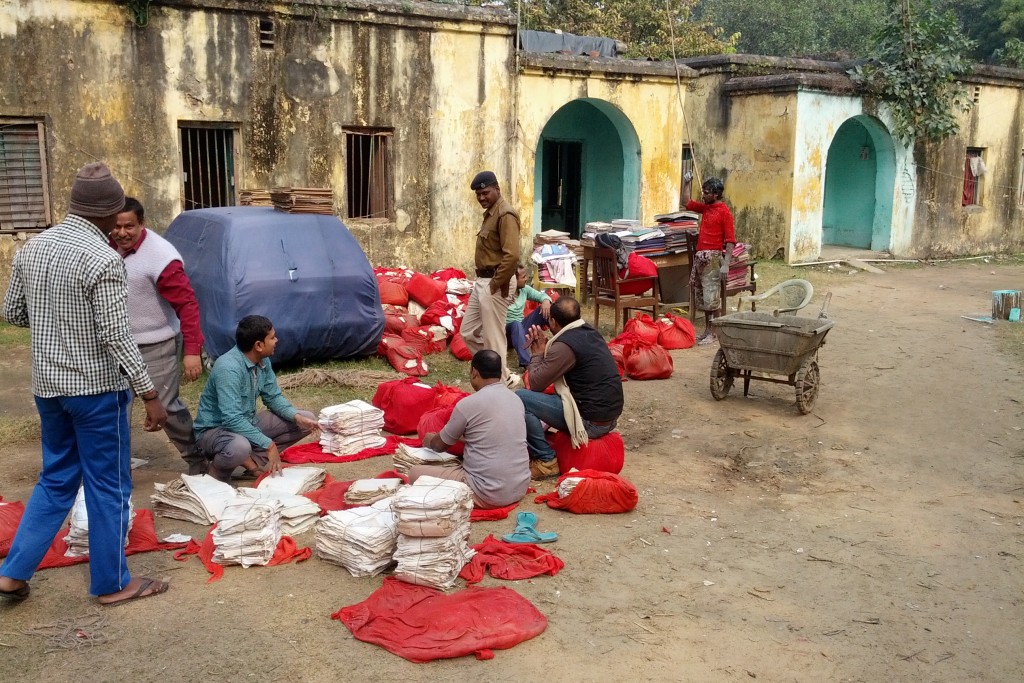 UConn economist Nishith Prakash and his team collected monthly police station criminal data from 853 police stations in the state of Bihar, India. Most of the data was stored in paper files in red bags, pictured. The process took two years. (Photo courtesy of Nishith Prakash)