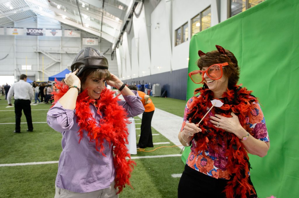 Raelene DeRobertis, left, and Teresa Barber-Tournaud, both from the Center for Clean Energy Engineering, dress up for a photo at the Mark R. Shenkman Training Center during the Employee Appreciation Day event on May 11, 2016. (Peter Morenus/UConn Photo)