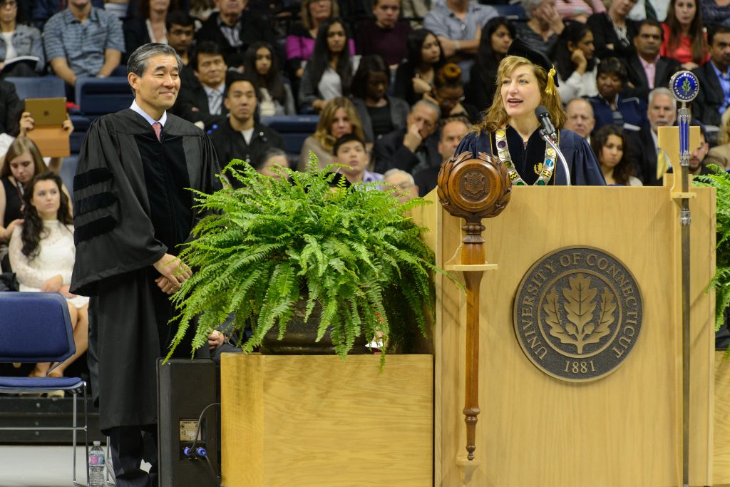 President Susan Herbst reads the citation to award John Kim '87 MBA an honorary degree during the School of Business commencement ceremony at Gampel Pavilion on May 8, 2016. (Peter Morenus/UConn Photo)
