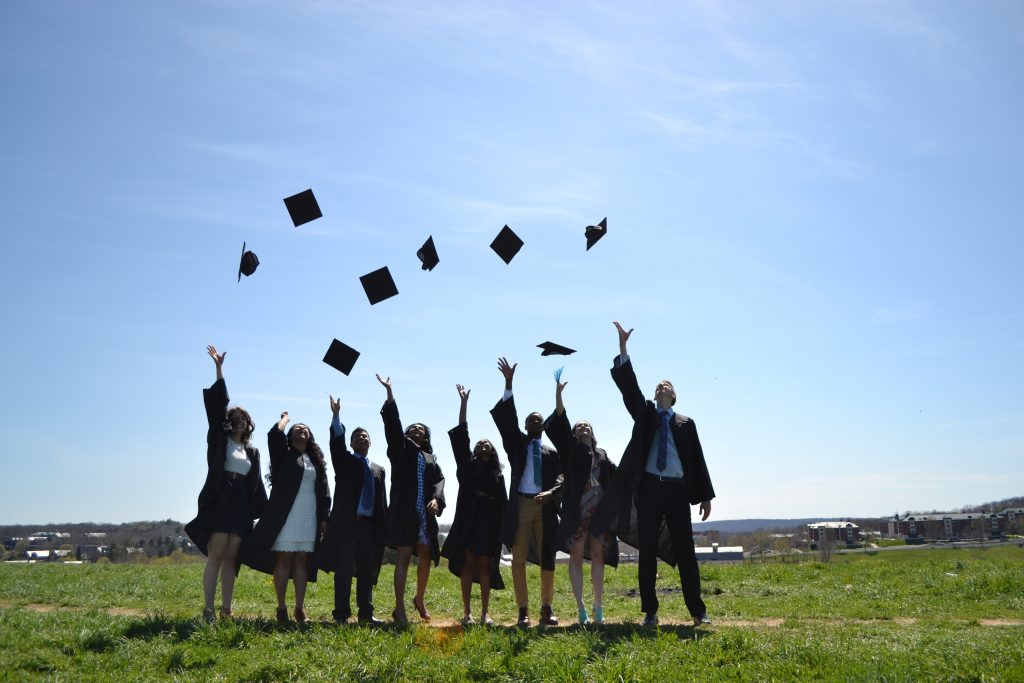 A group of seniors throw their caps in the air on top of Horsebarn Hill. (Gabriel Bachinelo '16 (BUS))