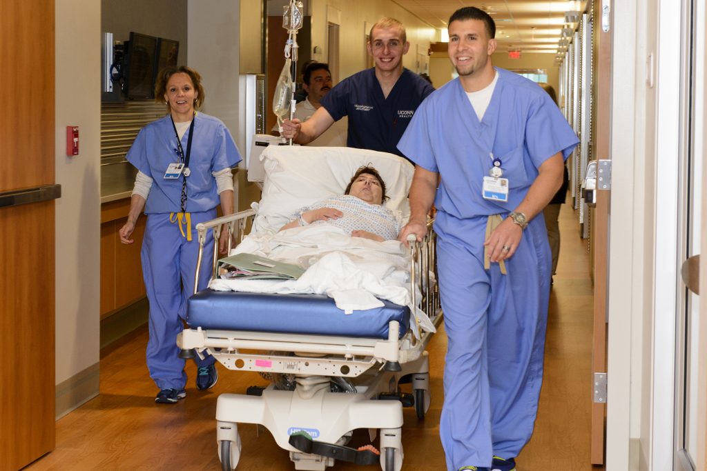 UConn Health nursing staff wheel a patient into the new hospital tower. (Janine Gelineau/UConn Health Photo)