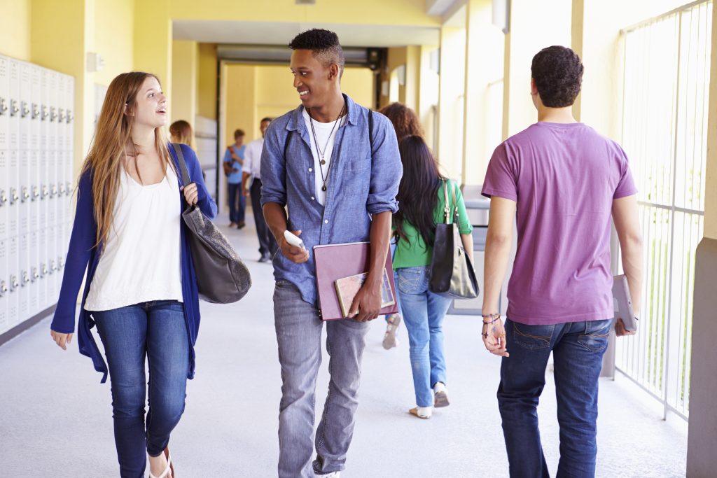A group of high school students walking in a hallway. (iStock Photo)