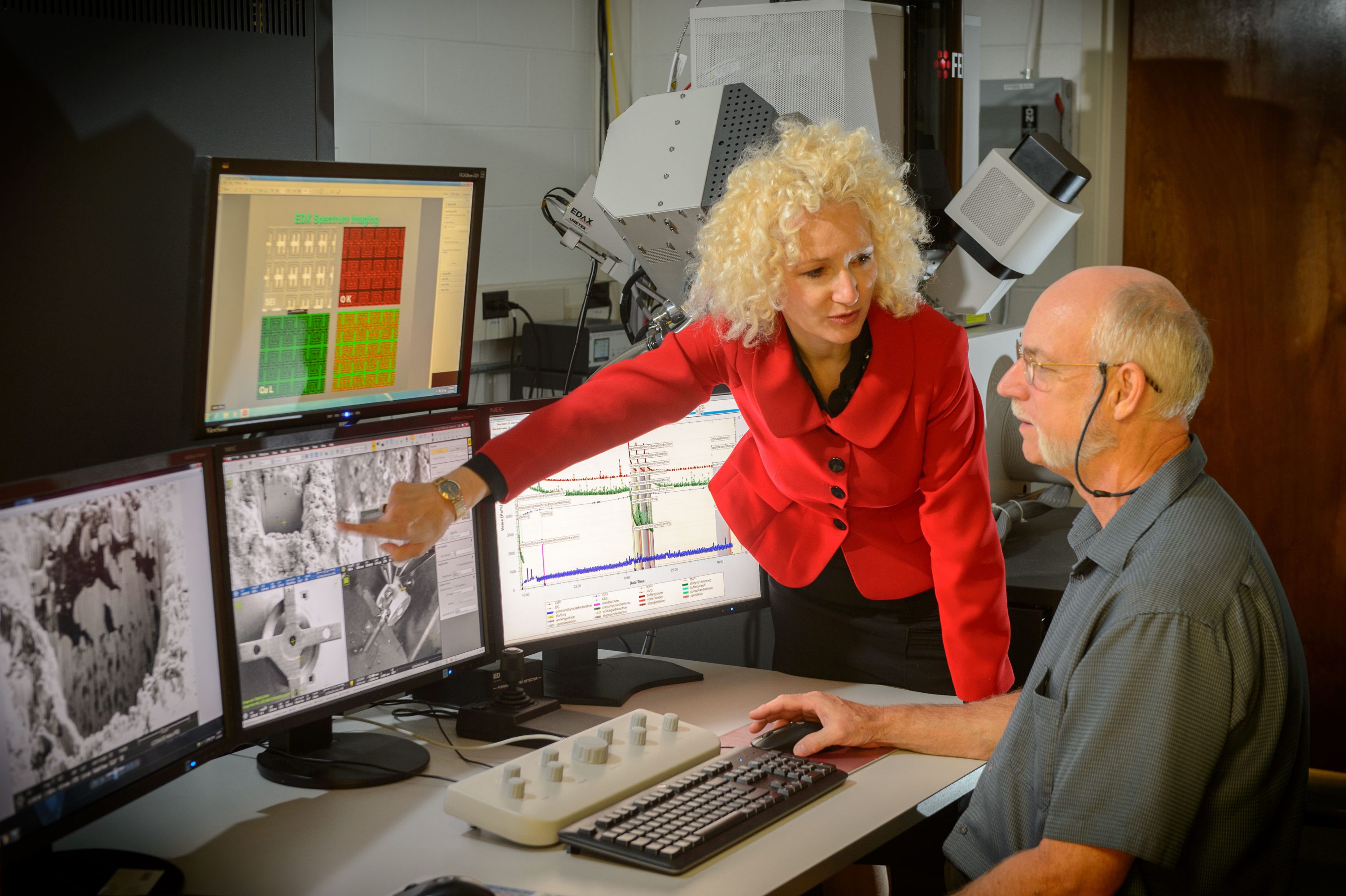 Radenka Maric, executive director of Tech Park, speaks with Roger Ristau, manager of the UConn-FEI Center for Advanced Microscopy and Materials Analysis. (Peter Morenus/UConn Photo)
