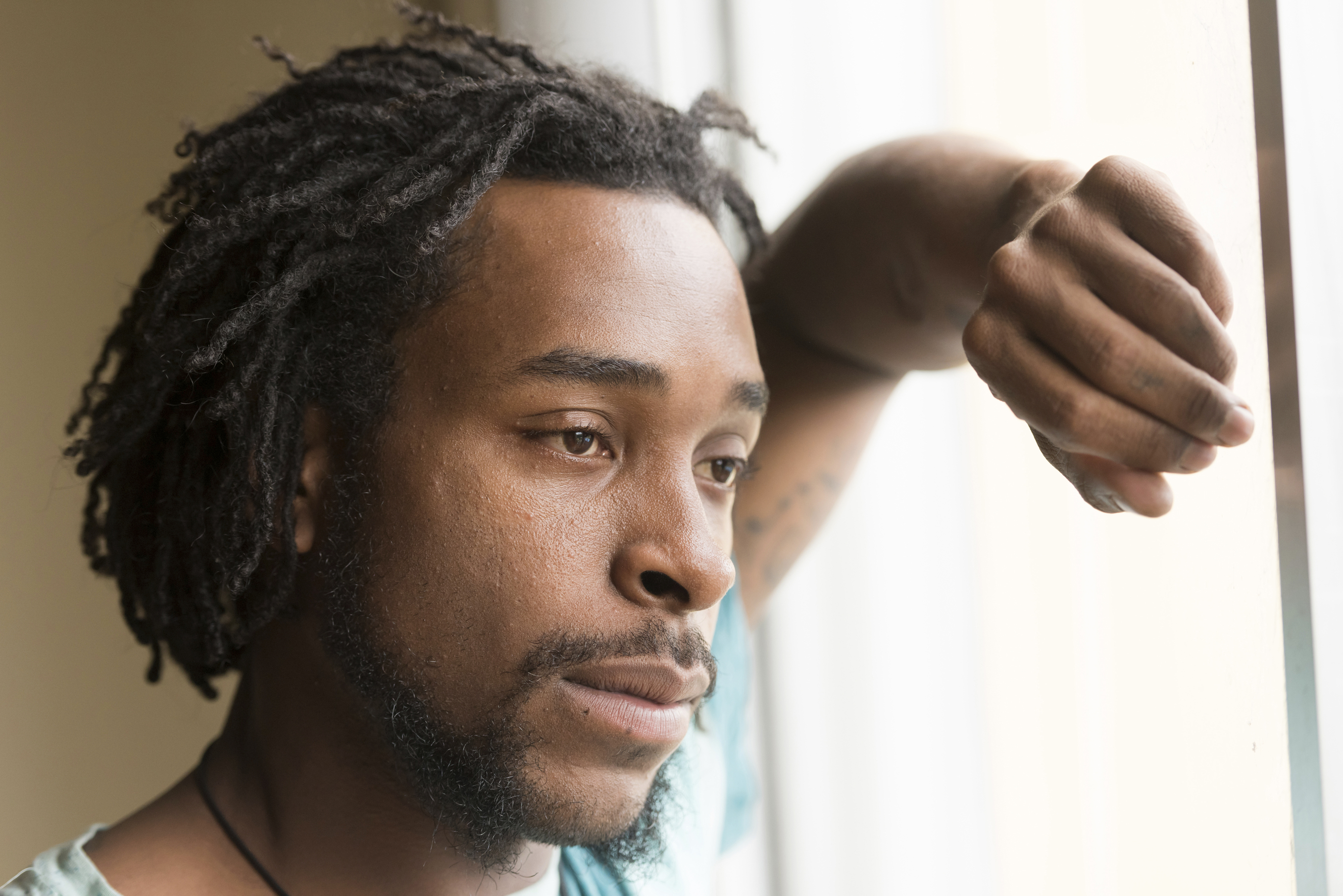 African American man looking through a window. (iStock Photo)