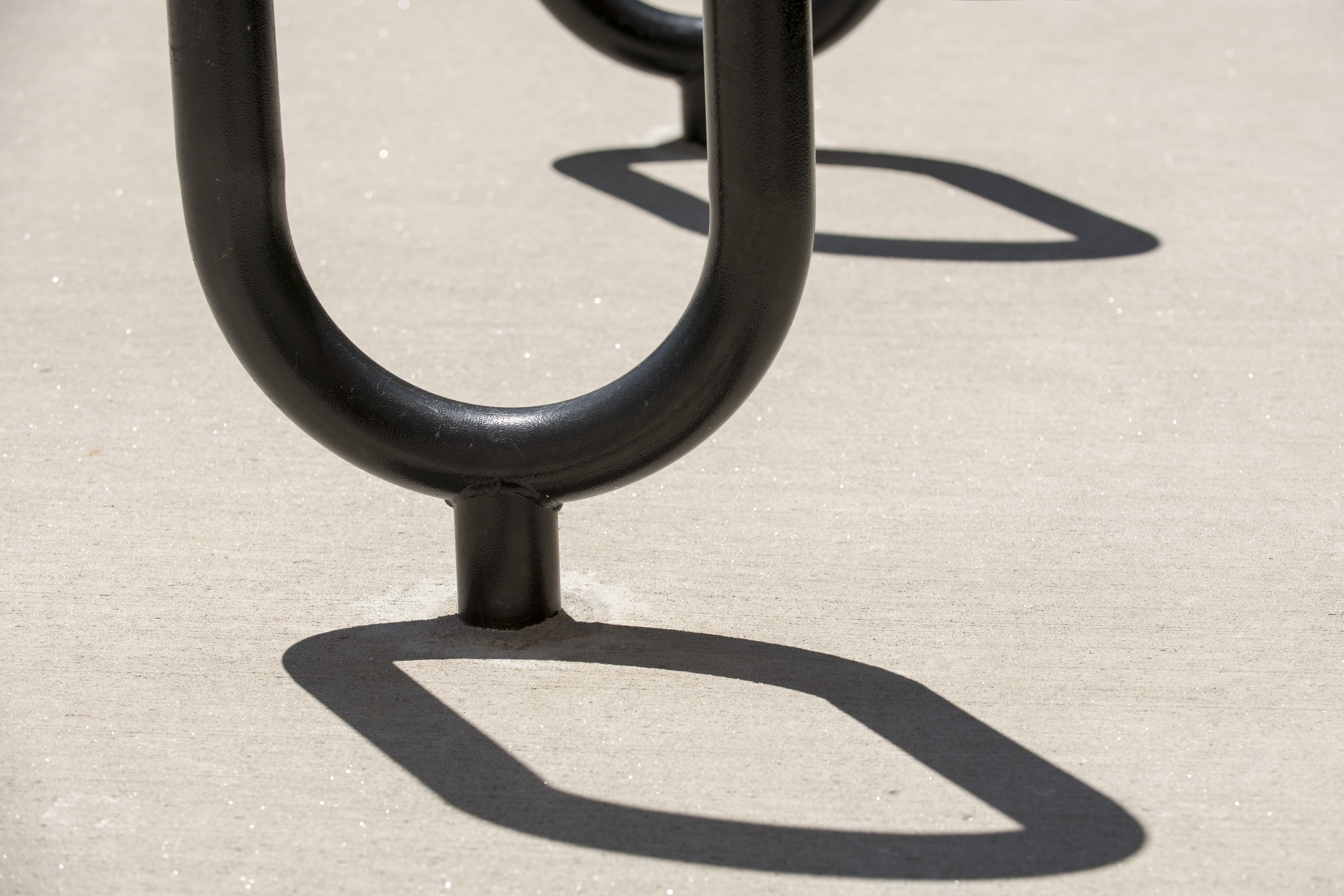 Shadows from a bicycle rack on July 26, 2016. (Sean Flynn/UConn Photo)