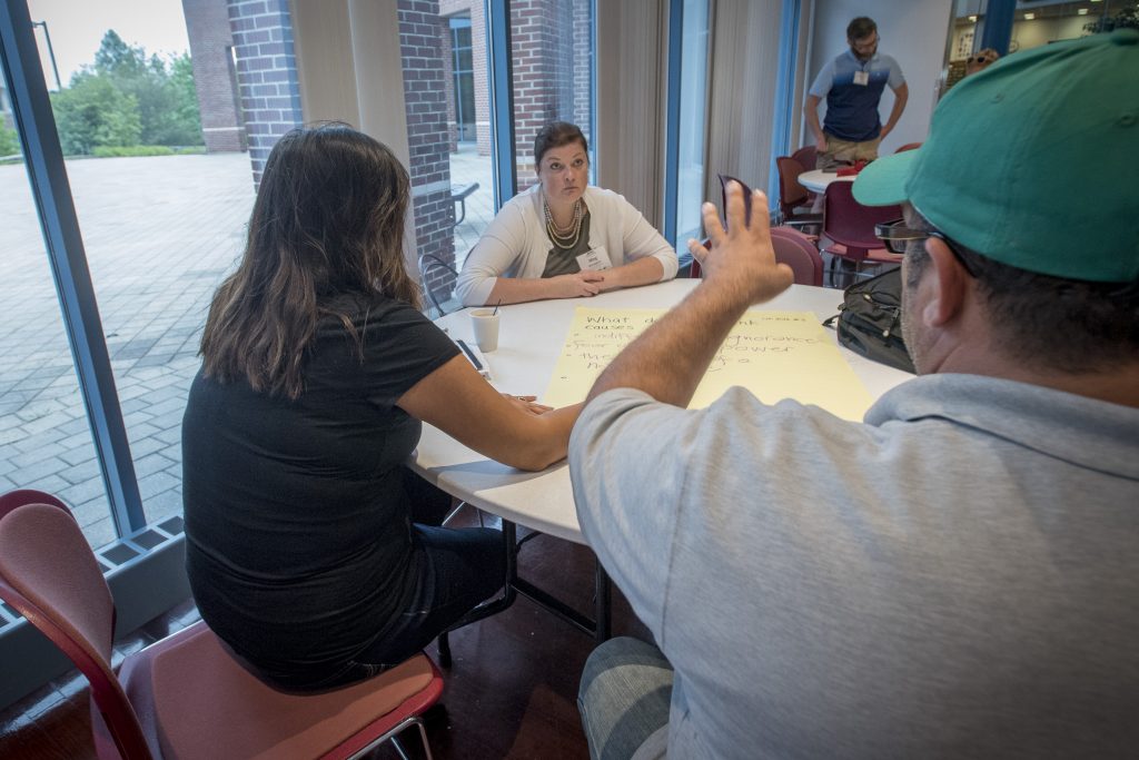 Attendees at the 2016 Intellectual Humility in Secondary Education Summer Institute discuss their beliefs on what causes genocide at the Thomas J. Dodd Research Center on Aug. 1, 2016. (Sean Flynn/UConn Photo)