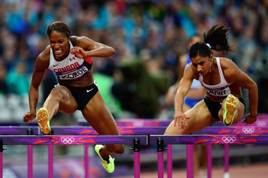 UConn alumna and Canadanian Phylicia George (left) competes in the women's 100-metre hurdle semifinals at the Olympic Stadium during the Summer Olympics in London in 2012. (THE CANADIAN PRESS/Sean Kilpatrick)