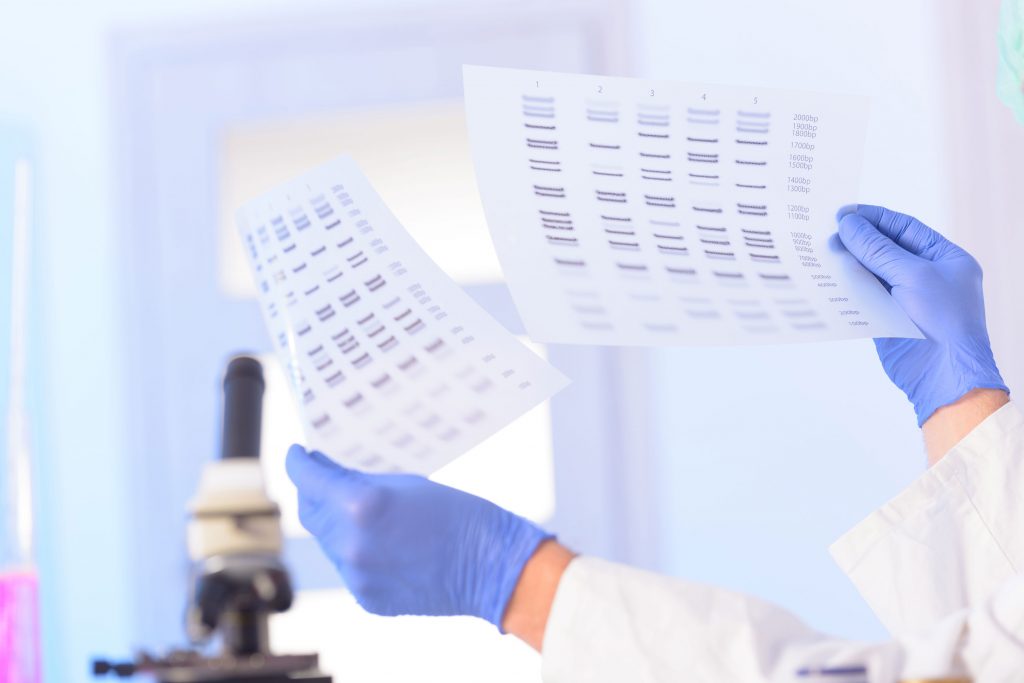 Scientist analyzing DNA sequence. (Shutterstock Photo)