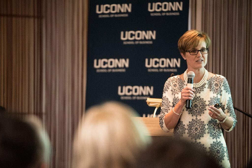 Corliss Montesi '86, vice president and corporate controller at Stanley Black & Decker, advises hundreds of enthusiastic students to embrace their personal brand at one of several graduate student Convocation events. (Nathan Oldham/UConn School of Business)