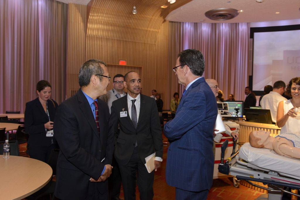 Gov. Dannel P. Malloy, right, speaks with Dr. Bruce T. Liang, left, and Dr. Andrew Agwunobi, during a ceremony at UConn Health Thursday to celebrate the opening of new biotechnology research space as part of the Bioscience Connecticut initiative. (Janine Gelineau/UConn Health Photo)