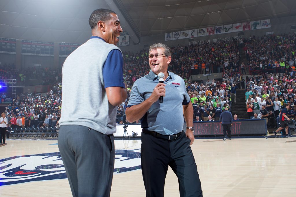 Men's basketball head coach Kevin Ollie, let, and women's basketball head coach Geno Auriemma share a joke during First Night 2015. (Stephen Slade '89 (SFA) for UConn)