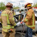 firefighters demonstrate jaws of life on a car