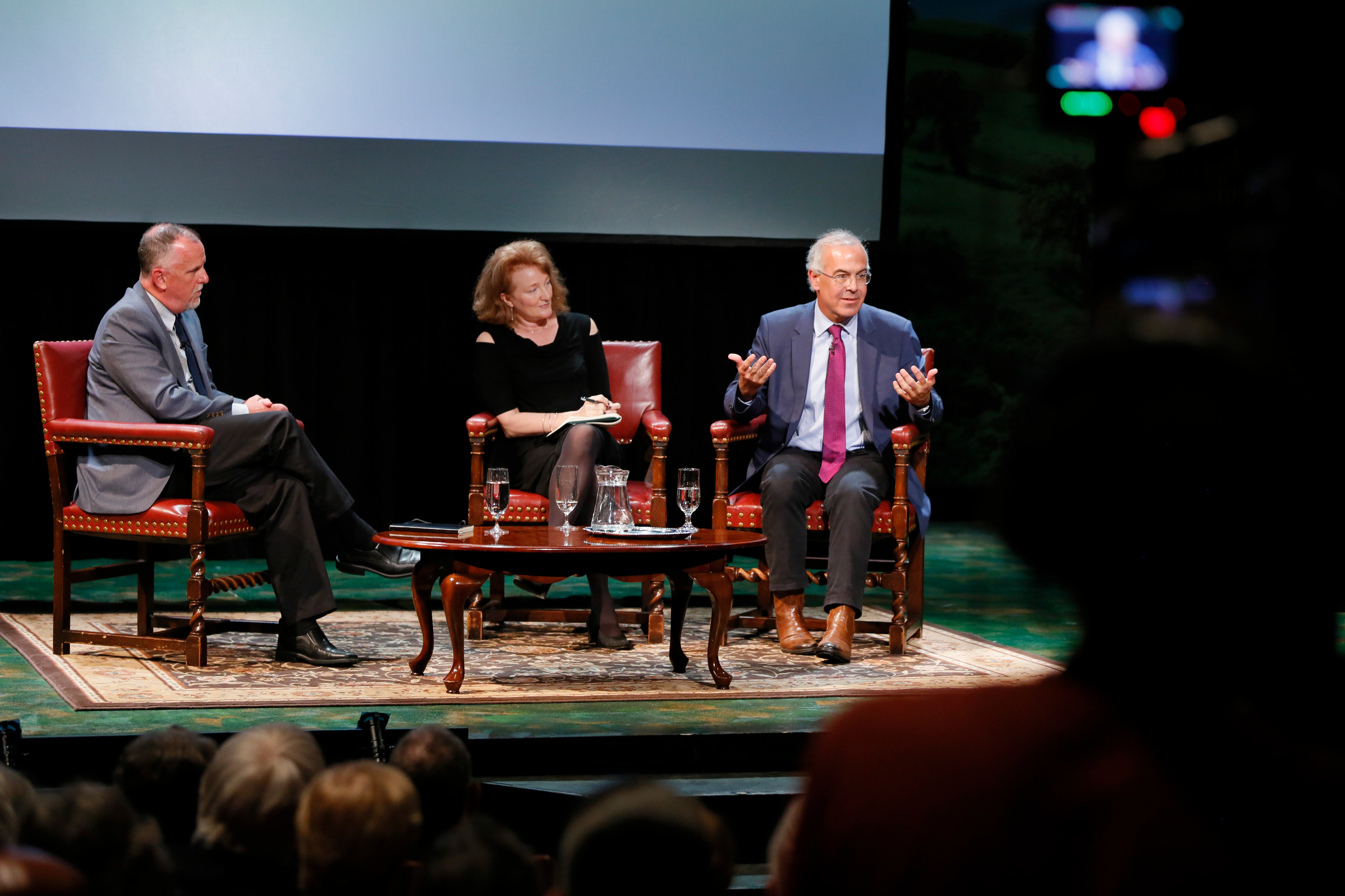 Michael Lynch, left, director of UConn's Humanities Institute, facilitates the panel discussion with Krista Tippet of NPR and David Brooks of the New York Times. (Photo by Garrett Hubbard, GH studios)