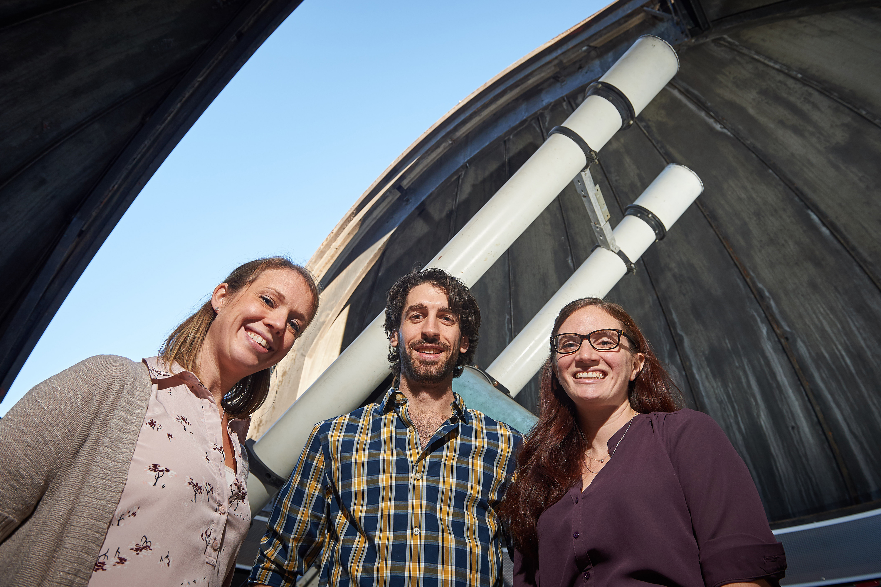New assistant professors of physics Kate Whitaker, left, Jonathan Trump, and Cara Battersby are building UConn’s first world-class program in astrophysics. They are pictured here at the UConn Physics Observatory. (Peter Morenus/UConn Photo)