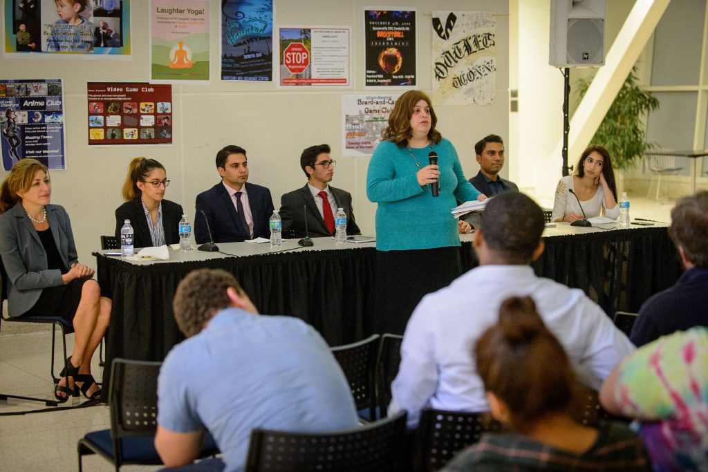 Beth Ginsberg, professor of political science, introduces a panel discussion on the U.S. presidential candidates held in the Rich Concourse at the Stamford campus before the televised third presidential debate on Oct. 19, 2016. (Peter Morenus/UConn Photo)